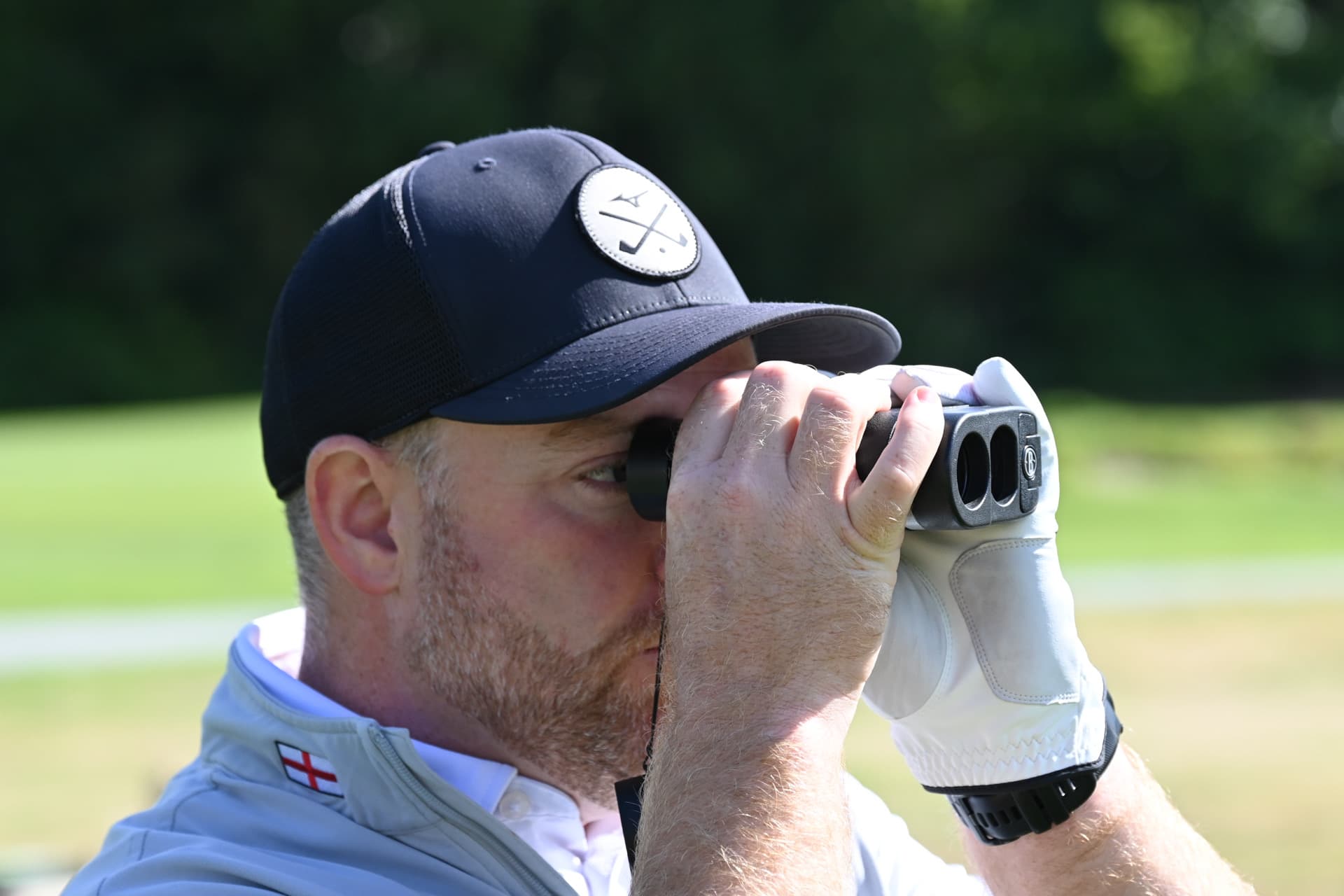 Ollie Greenham checking a yardage with a laser rangefinder
